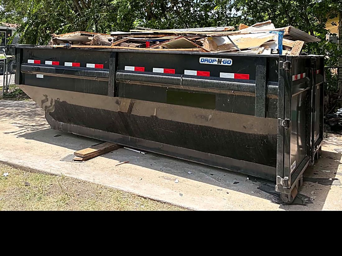 Roll-off dumpster loaded with remodel debris