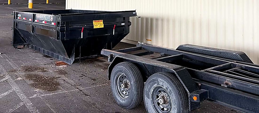 Dumpster and trailer dropped at a commercial site