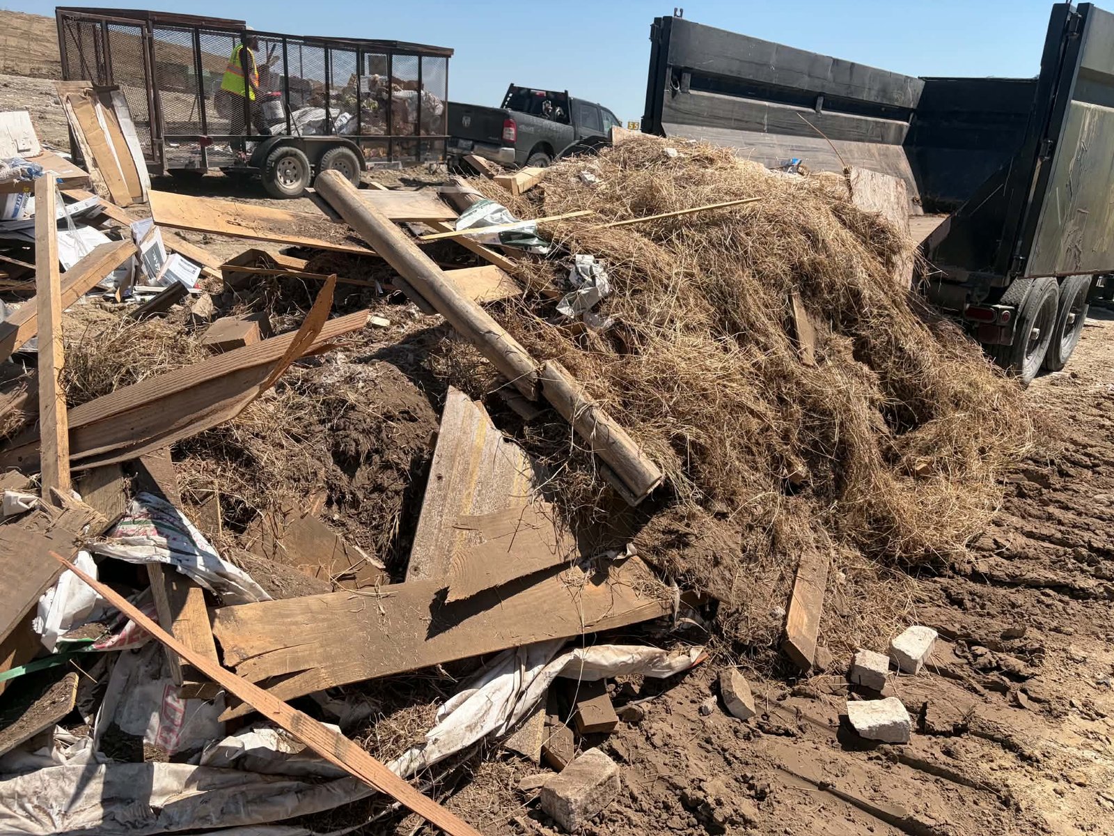 Dump trailer unloading lumber, brush and debris at the landfill